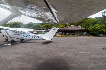 CANAIMA, VENEZUELA - AUGUST 18, 2015:  Cessna aiplanes at the airstrip in Canaima village, Venezuela