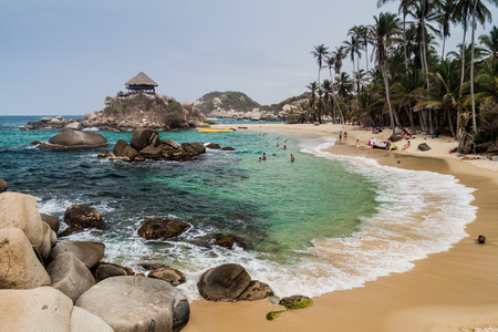 TAYRONA, COLOMBIA - AUGUST 26, 2015: People enjoy beautiful waters of Carribean sea in Tayrona National Park, Colombiaの写真素材