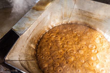 Detail of sugar cane juice being boiled. This is a part of a process of producing panela (unrefined...