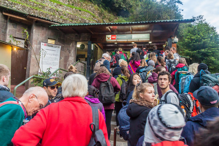 MACHU PICCHU, PERU - MAY 18, 2015: Visitors are waiting at the entrance to Machu Picchu ruins, Peru.