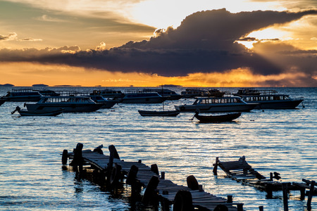 Sunset in a harbor  of Copacabana town on Titicaca lake, Boliviaの写真素材