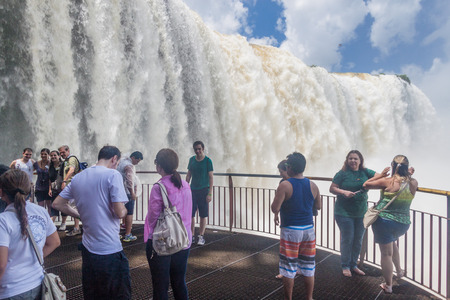 IGUACU, BRAZIL - FEB 5, 2015: Tourists admire Iguacu (Iguazu) falls on a border of Brazil and Argentinaの写真素材