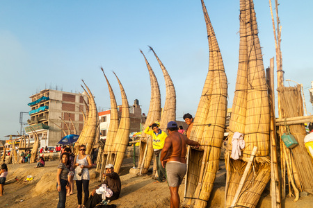 HUANCHACO, PERU - JUNE 6, 2015: Traditional reed boats on a beach in Huanchaco, Peru.のeditorial素材