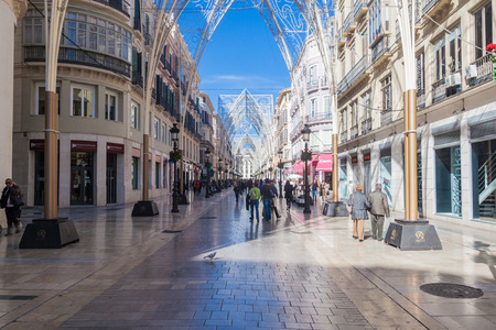 MALAGA, SPAIN - JAN 25, 2015: People walk through decorated pedestrianized Calle Larios in Malaga.のeditorial素材