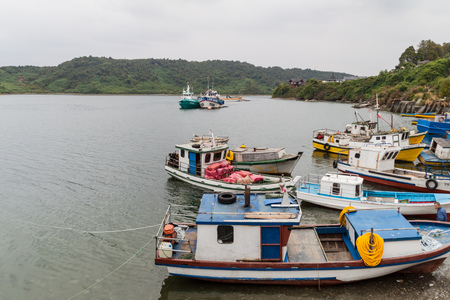 PUERTO MONTT, CHILE - MARCH 1, 2015: Fishing boats in a harbor of Puerto Montt, Chileのeditorial素材