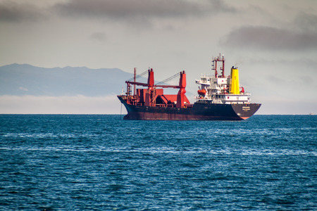 PUERTO MONTT, CHILE - MAR 23: Cargo ship near Puerto Montt city, Chileのeditorial素材