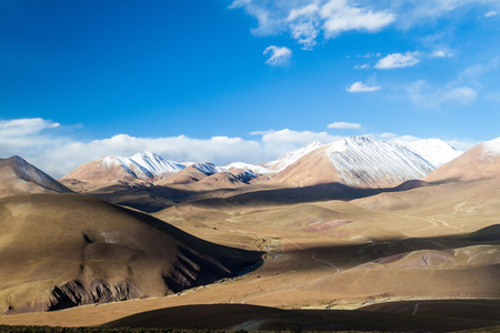 Snow covered mountains soaring from altiplano in Boliviaの写真素材