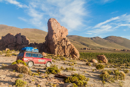 SOUTHWESTERN BOLIVIA - APRIL 16, 2015: 4WD vehicle carries group of tourists at the popular Salar de Uyuni tour.のeditorial素材
