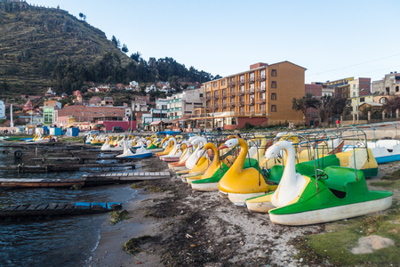 Swan shaped tourist boats in a harbor of Copacabana town on Titicaca lake, Boliviaのeditorial素材
