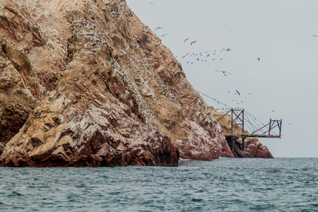 Guano loading post on the rocks of the Ballestas Islands in the Paracas National park, Peru.の写真素材