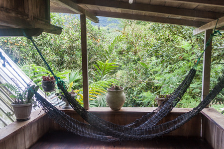 MINDO, ECUADOR - JUNE 27, 2015: Hammocks in La Casa de Cecilia hostel in Mindo village.の写真素材