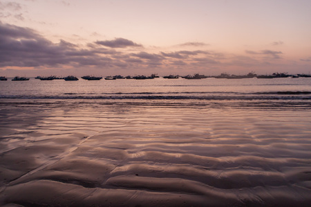 Fishing boats and a beach in Puerto Lopez, Ecuadorの写真素材