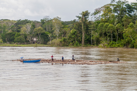 NAPO, PERU - JULY 16, 2015: Local people transport logs on river Napo.のeditorial素材