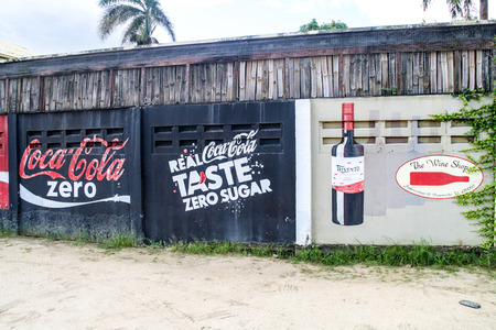 PARAMARIBO, SURINAME - AUGUST 6, 2015: Hand painted advertisements on walls of Paramaribo, capital of Suriname.のeditorial素材