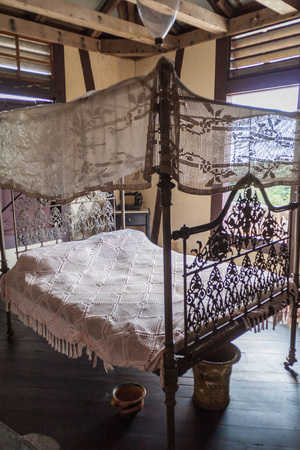 LA GRAN PIEDRA, CUBA - FEB 2, 2016: Bed in Cafetal la Isabelica coffee growing plantation mansion, Sierra Maestra mountain range, Cubaのeditorial素材