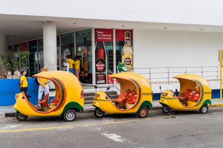 HAVANA, CUBA - FEB 21, 2016: Row of coco taxis in front of Hotel Habana Libre located in the Vedado neighborhood of Havana.の写真素材