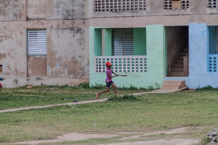 GIBARA,  CUBA - JAN 29, 2016: Boy plays the baseball in Gibara village, Cubaのeditorial素材