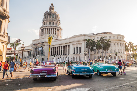 HAVANA, CUBA - FEB 20, 2016: Colorful vintage cars wait for tourists in Parque Central in Havana in front of the National Capitol.のeditorial素材