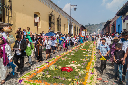 ANTIGUA, GUATEMALA - MARCH 27, 2016: Participants of the procession on Easter Sunday walk along the created carpet in Antigua Guatemala city.のeditorial素材
