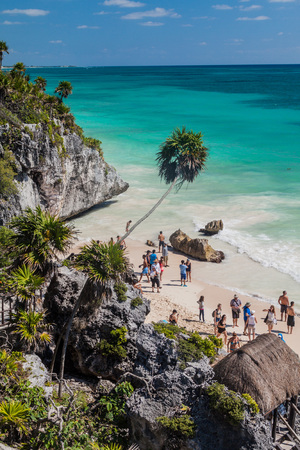 TULUM, MEXIO - FEB 29, 2016: Tourists at the beach under the ruins of the ancient Maya city Tulum, Mexicoの写真素材