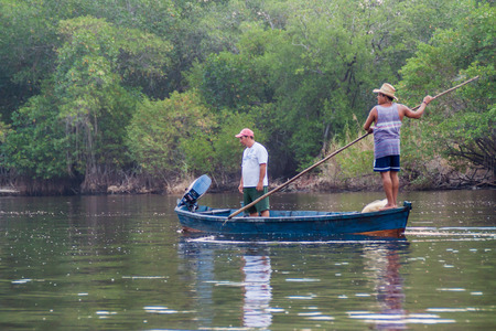 MONTERRICO, GUATEMALA - MARCH 30, 2016: Boatmen in the wetlands of the wildlife reserve Biotopo Monterrico-Hawaii, Guatemalaのeditorial素材