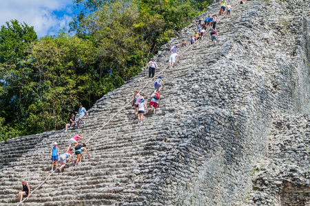 COBA, MEXICO - MARCH 1, 2016: Tourist climb the Pyramid Nohoch Mul at the ruins of the Mayan city...