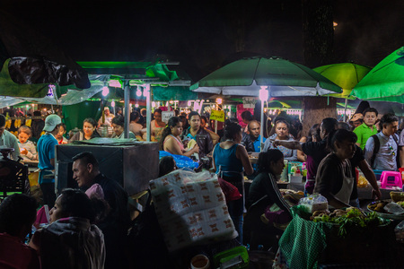 ANTIGUA, GUATEMALA - MARCH 25, 2016: People eat at the food stalls in Antigua Guatemala city.のeditorial素材