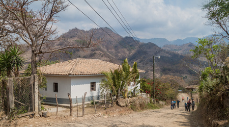 SAN MANUEL DE COLOHETE, HONDURAS - APRIL 15, 2016: Rural road in San Manuel village.のeditorial素材