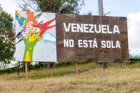 LAS TUNAS, CUBA - JAN 27, 2016: Propaganda billboard at Plaza de la Revolucion (Square of the Revolution) in Las Tunas. It says: Venezula is not alone.の写真素材