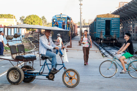 CAMAGUEY, CUBA - JAN 26, 2016: People are crossing the railway tracks in Camaguey