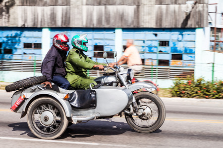 CAMAGUEY, CUBA - JAN 26, 2016: Motorcycle with a side car on a road in Camagueyのeditorial素材