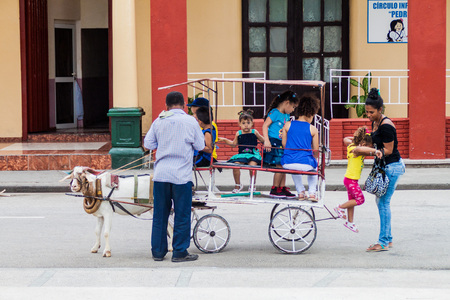 BAYAMO,  CUBA - JAN 30, 2016: Kids enjoy a goat ride on Cespedes square  in Bayamo, Cubaのeditorial素材