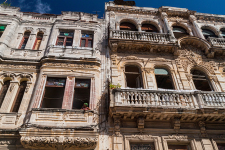 HAVANA, CUBA - FEB 22, 2016: Local woman watches out of the window in a dilapidated house in Havana Centro neighborhood, Havana, Cubaのeditorial素材
