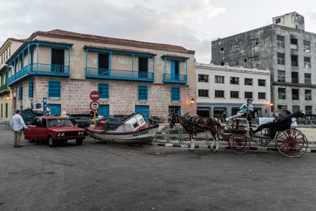 HAVANA, CUBA - FEB 20, 2016: Car, boat and a horse carriage in Old Havana.のeditorial素材