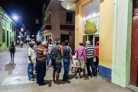 SANTIAGO DE CUBA,  CUBA - JAN 31, 2016: People ar waiting at the queue for the bread at the...