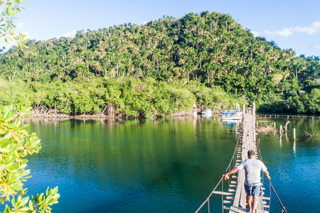 BOCA DE MIEL, CUBA - FEB 4, 2016: Hanging bridge over Rio Miel river near Baracoa, Cubaのeditorial素材