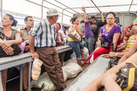 BAYAMO,  CUBA - JAN 31, 2016: People ride in a truck in Bayamo. In Cuba, trucks often carry passengers.のeditorial素材