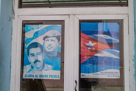 HOLGUIN, CUBA - JAN 28, 2016: Propaganda poster celebrating Hugo Chavez in Holguin, Cuba. It says: Glory to the brave peoples.のeditorial素材