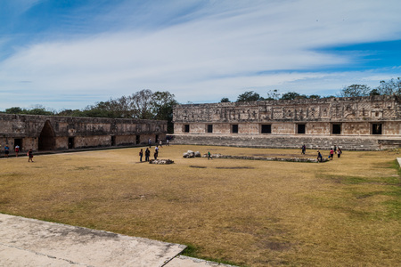 UXMAL, MEXICO - FEB 28, 2016: Tourists at the courtyard of the Nun's Quadrangle (Cuadrangulo de las Monjas) building complex at the ruins of the ancient Mayan city Uxmal, Mexicoのeditorial素材