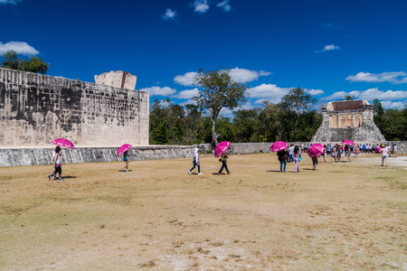 CHICHEN ITZA, MEXICO - FEB 26, 2016: Crowds of tourists visit The great ball game court at the...