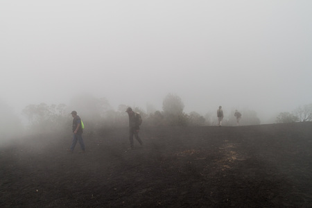 PACAYA, GUATEMALA - MAR 28, 2016: Tourists visiting the Pacaya volcano in the mist, Guatemalaの写真素材