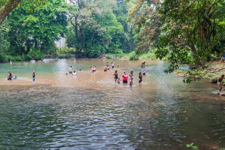 PULHAPANZAK, HONDURAS - APRIL 18, 2016: People are bathing in a river above Pulhapanzak waterfall.のeditorial素材