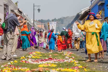 ANTIGUA, GUATEMALA - MARCH 27, 2016: Participants of the procession on Easter Sunday walk along the created carpet in Antigua Guatemala city.のeditorial素材
