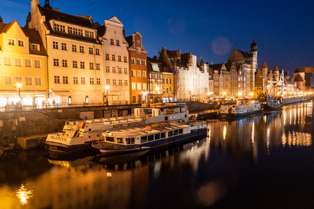 GDANSK, POLAND - SEPTEMBER 1, 2016: Evening view of riverside houses by Motlawa river in Gdansk,...