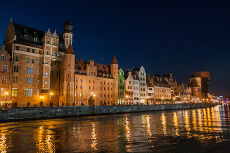 GDANSK, POLAND - SEPTEMBER 1, 2016: Evening view of riverside houses by Motlawa river in Gdansk,...