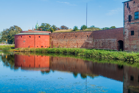 Fortification walls of Malmo Castle reflecting in its moat, Swedenの写真素材
