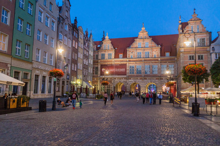 GDANSK, POLAND -  SEPTEMBER 1, 2016: Evening view of people walk along historic houses at Dlugi Targ...