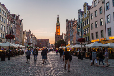 GDANSK, POLAND -  SEPTEMBER 1, 2016: Evening view of people walk along historic houses at Dlugi Targ...
