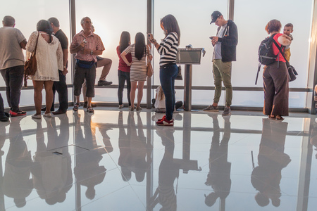 DUBAI, UAE - OCTOBER 21, 2016: People at the Observation Deck of Burj Khalifa skyscraper, United...