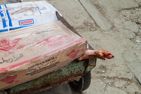 HAVANA, CUBA - FEB 22, 2016: Pig leg sticking out of a cart on a street in Havana, Cuba.のeditorial素材